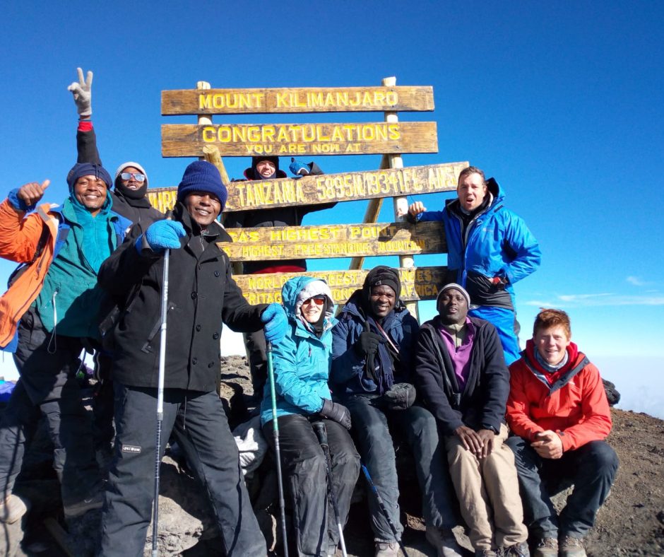 Tourists standing on the Roof of Africa! - Mt Kilimanjaro.